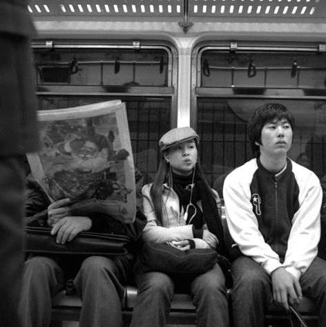 a subway newspaper and two boys