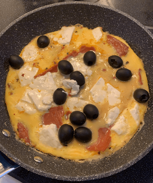 Black olives, veggie bacon, and eggs with feta