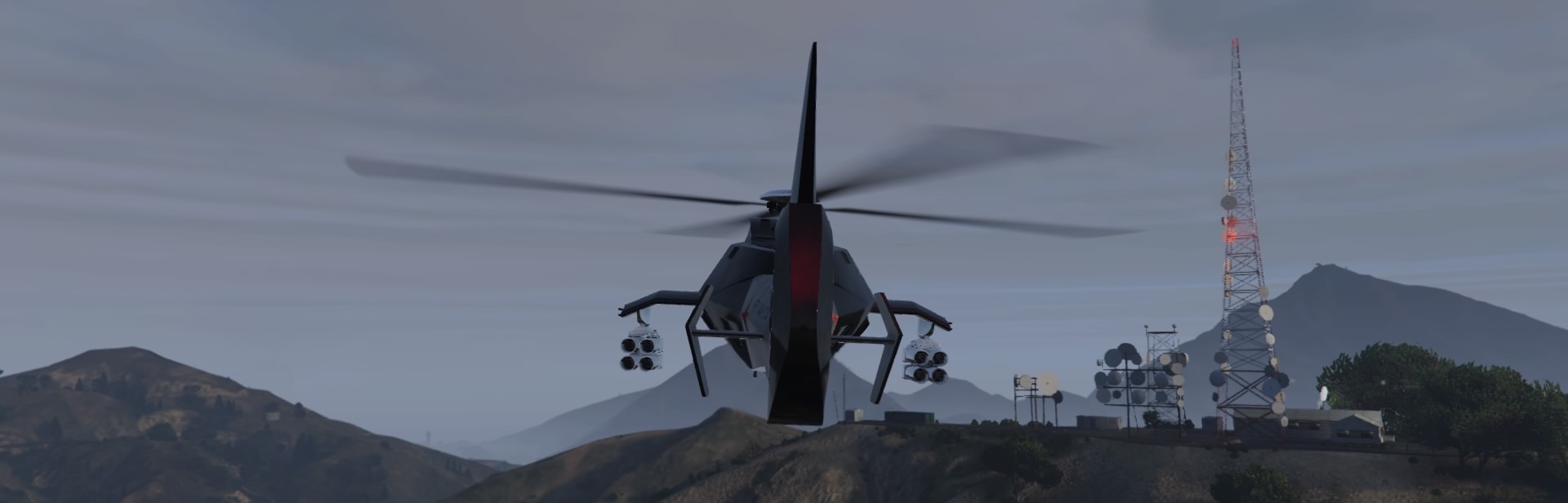 Dark red ghost helicopter next to radio base 