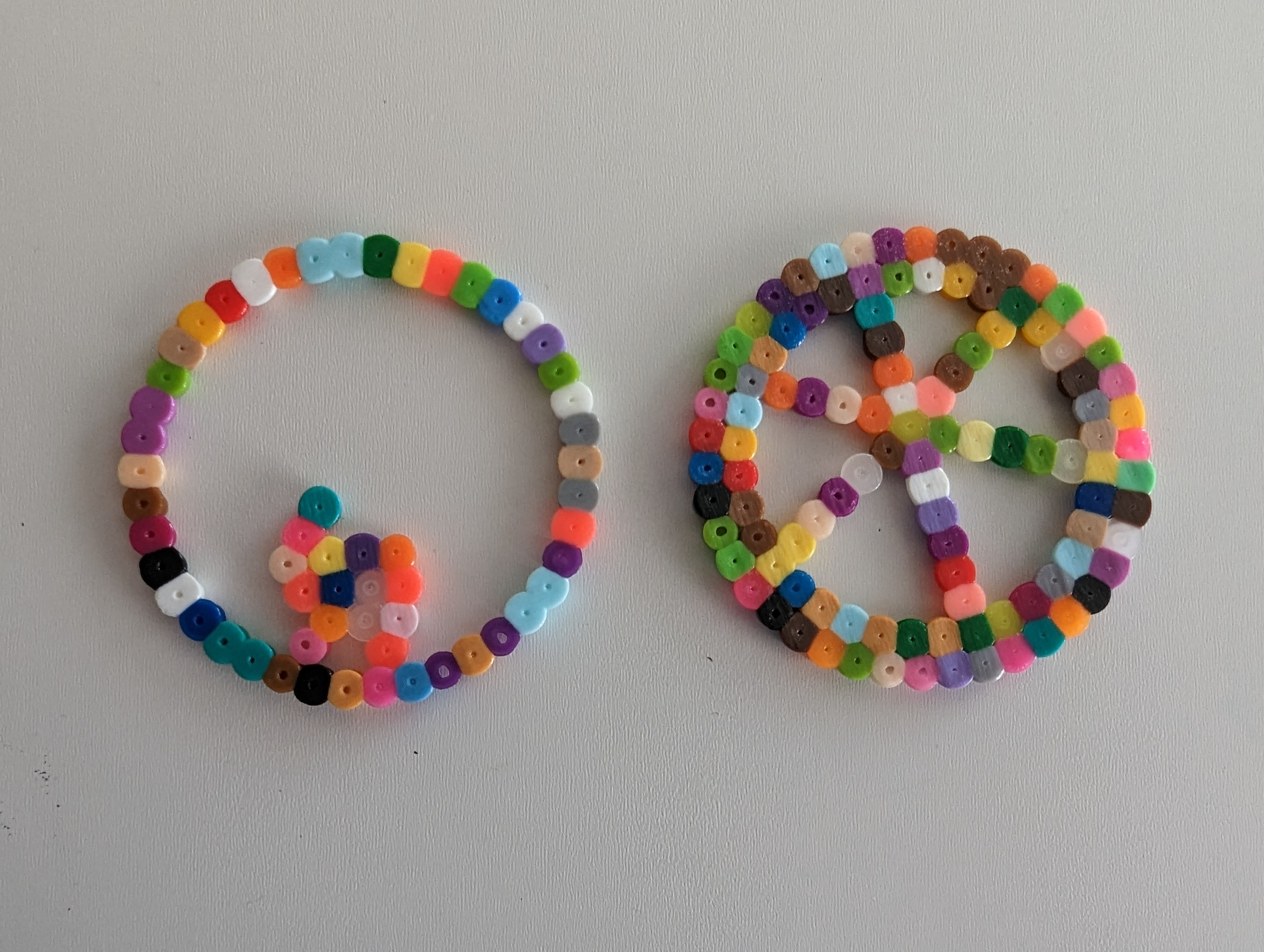 A hamster in a wheel and a wheel with spokes in Perler beads