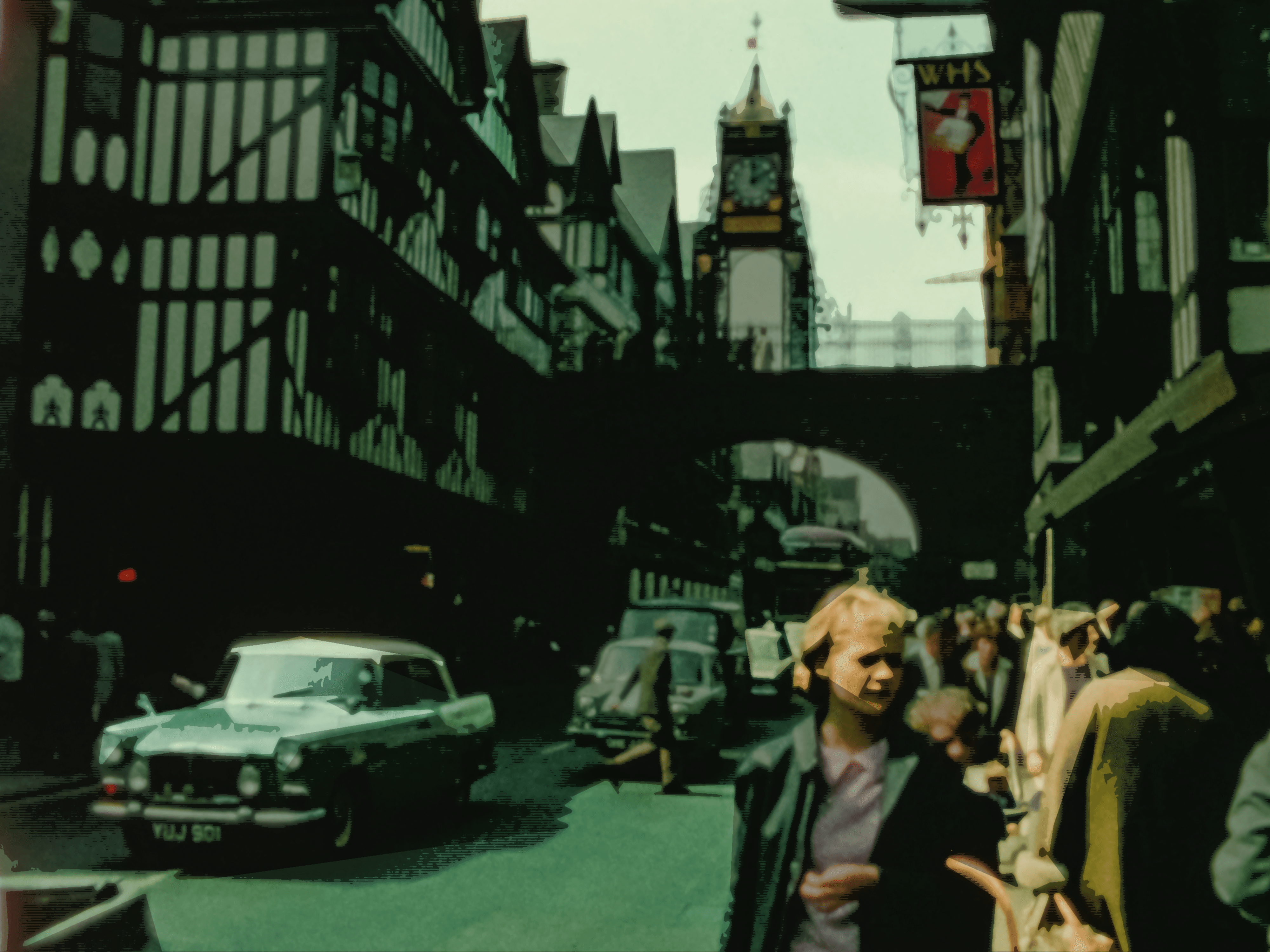 People and cars pass under the Eastgate and Eastgate Clocks. Today this is the UK's most photographed monumental clock. Chester, UK