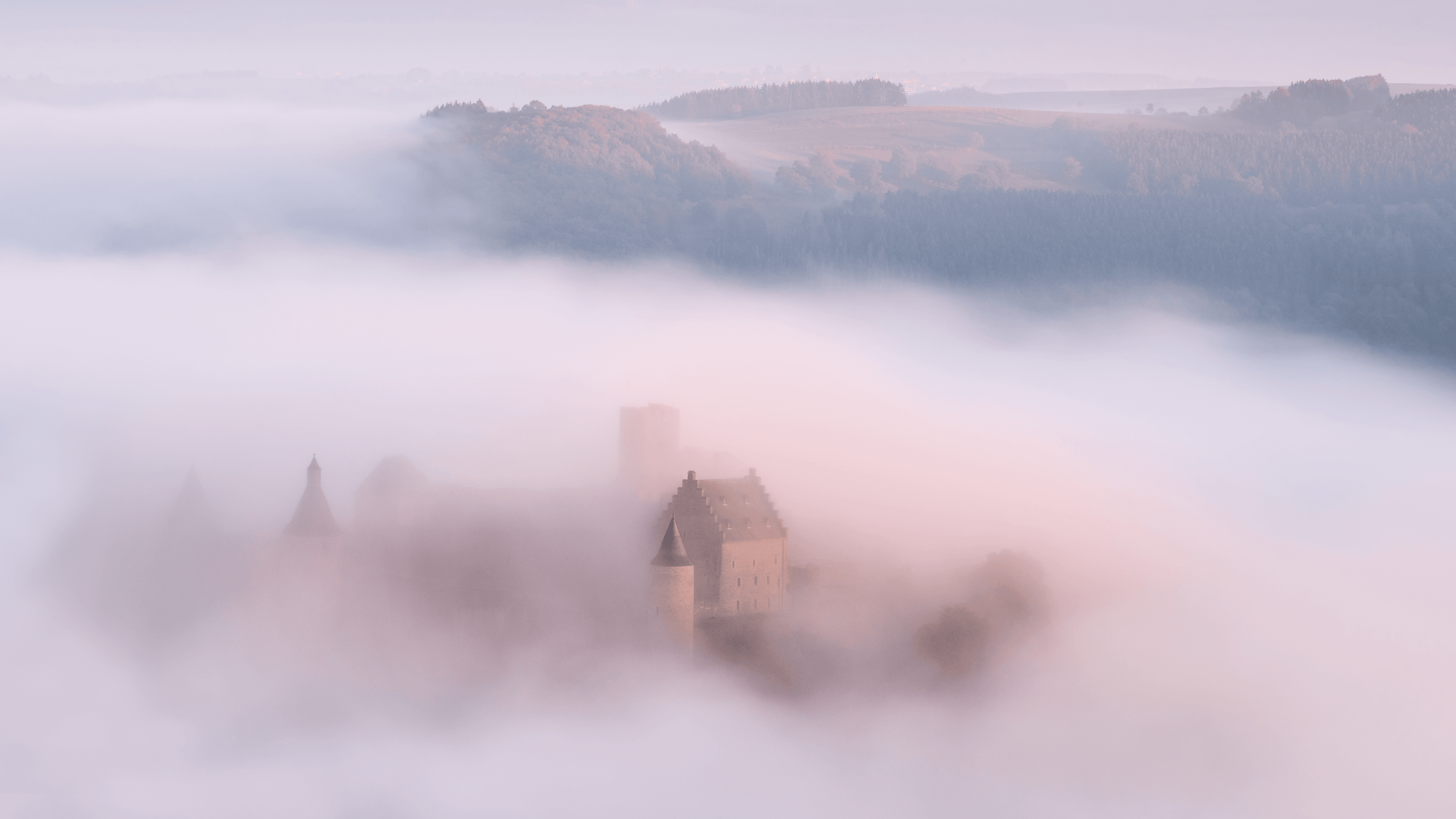 Bourscheid Castle floating in fog