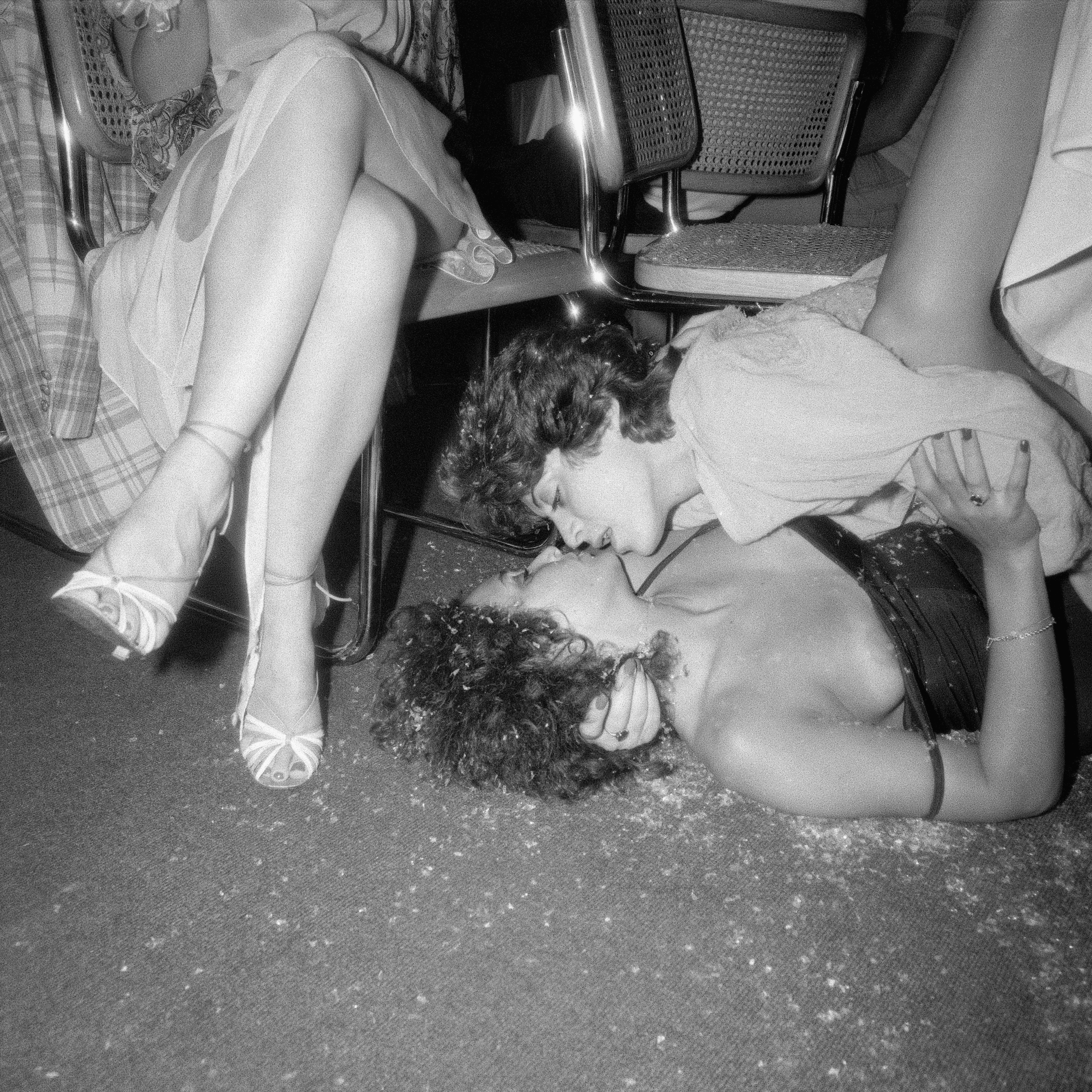 QuirkyVision 45RPM - Women Embrace on Floor Near JudiJupiter’s Legs