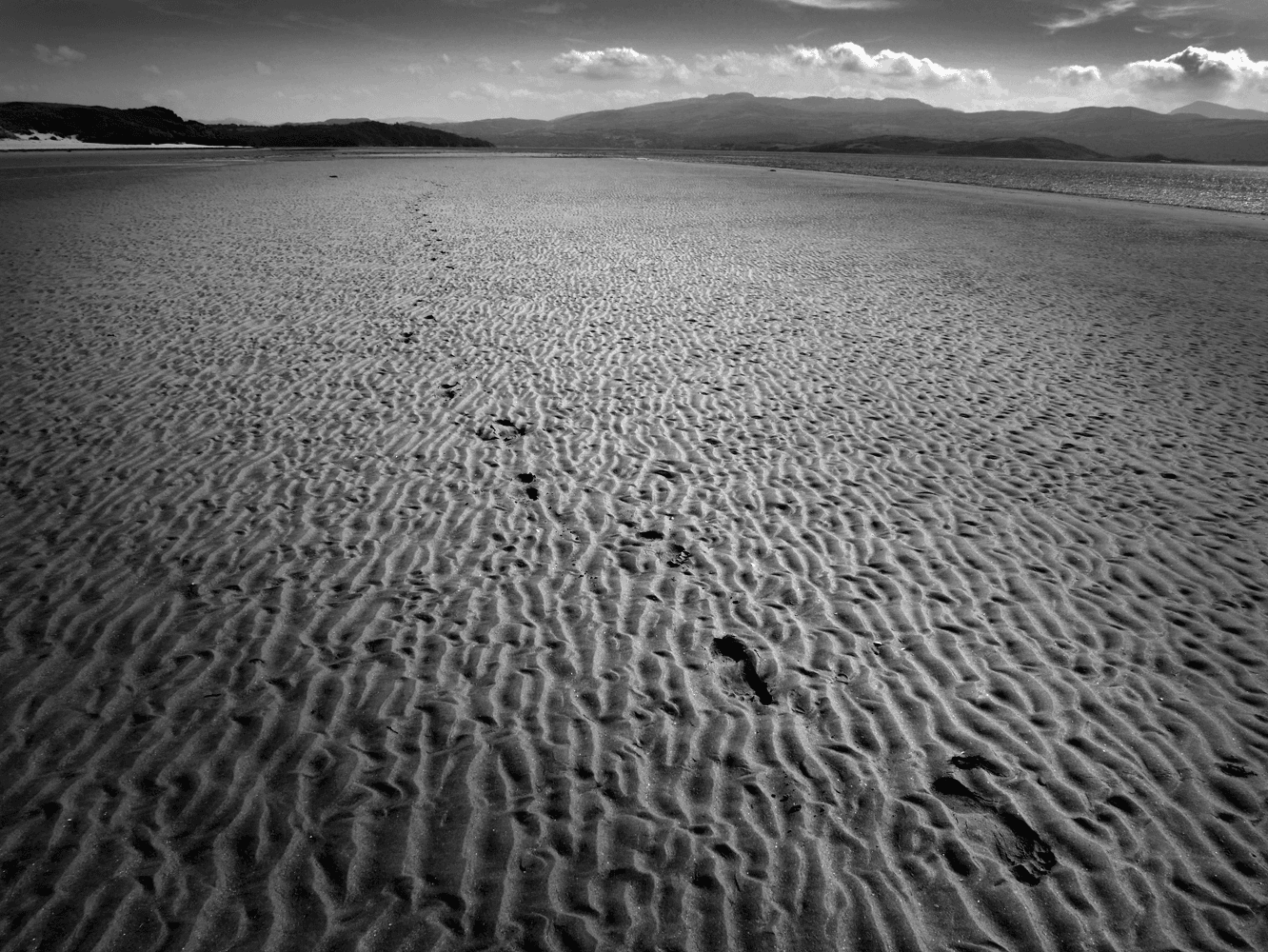 Footsteps in the Sand on a Deserted Beach